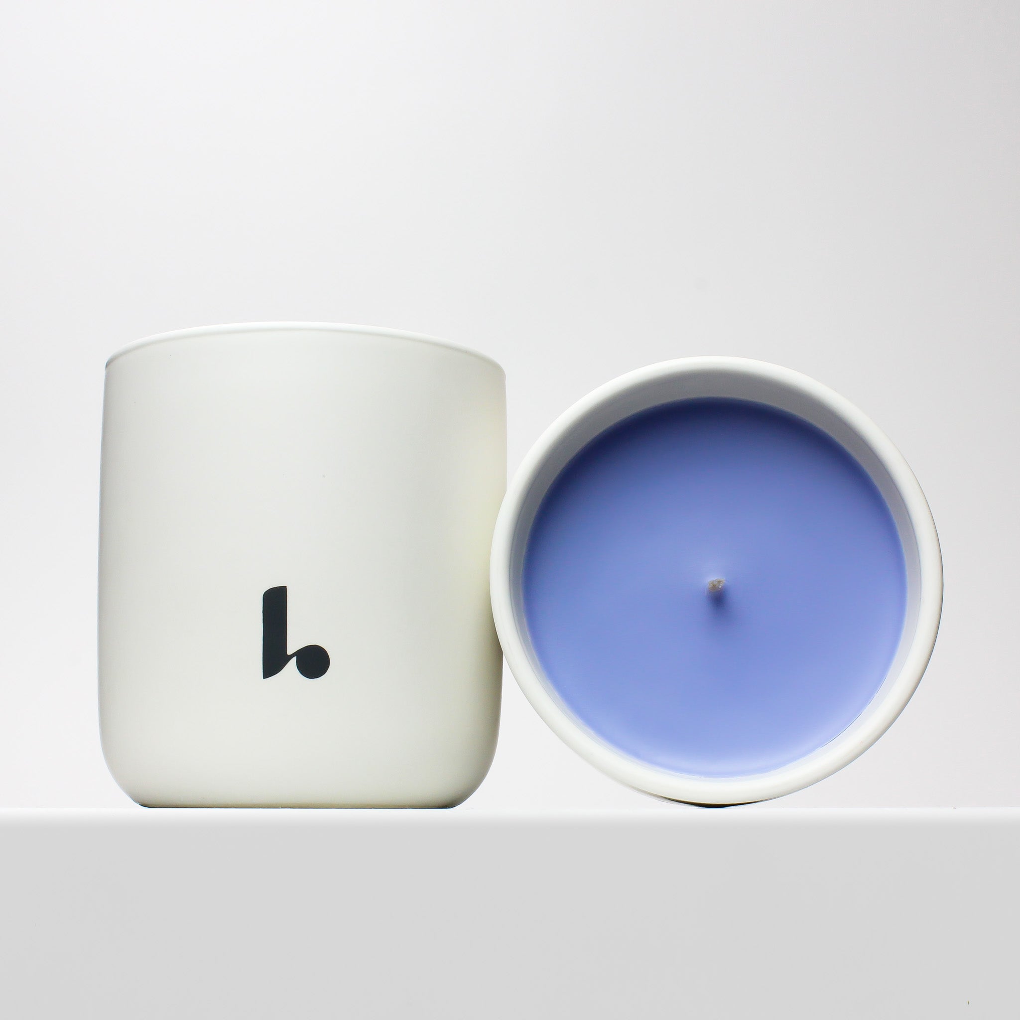 Cape Horizon scented candle with light blue soy wax housed in a white ceramic vessel